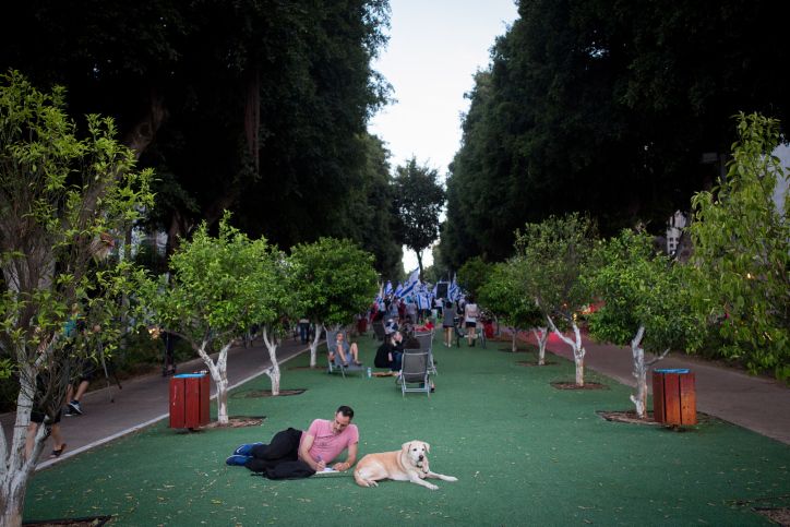 A man sits with his dog in Tel Aviv, Israel, on May 26, 2020.